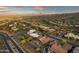 Stunning aerial view of a desert community with mountain views, lush landscaping, and beautiful sunset skies at 15600 E Robin Dr, Fountain Hills, AZ 85268