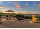 Landscaped backyard featuring a stone table with umbrella and tiered fountain at 15600 E Robin Dr, Fountain Hills, AZ 85268