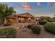 Picturesque backyard with lush landscaping, covered patio, and a tranquil water feature at 15600 E Robin Dr, Fountain Hills, AZ 85268