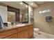 Bathroom with a granite countertop vanity, decorative mirror, and tiled shower with a curtain at 15600 E Robin Dr, Fountain Hills, AZ 85268