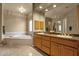 This bathroom features double sinks, a large mirror, a bathtub, and granite countertops at 15600 E Robin Dr, Fountain Hills, AZ 85268
