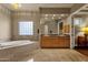 Bright bathroom features a soaking tub, double sinks with granite countertops and tile flooring at 15600 E Robin Dr, Fountain Hills, AZ 85268