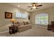 Bedroom with carpeted floors, a ceiling fan, plantation shutters, and a comfortable beige sofa at 15600 E Robin Dr, Fountain Hills, AZ 85268
