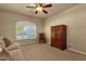 Bedroom featuring carpeted floors, a ceiling fan, plantation shutters, and a classic wooden wardrobe at 15600 E Robin Dr, Fountain Hills, AZ 85268