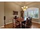 Formal dining room featuring hardwood floors, a coffered ceiling, and a large window with plantation shutters at 15600 E Robin Dr, Fountain Hills, AZ 85268