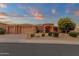 Inviting single-story home with a three-car garage, appealing landscaping, and covered front porch at 15600 E Robin Dr, Fountain Hills, AZ 85268