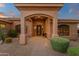 Inviting covered front porch featuring an ornate front door and desert landscaping at 15600 E Robin Dr, Fountain Hills, AZ 85268