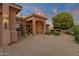 Covered front entrance with desert landscaping featuring mature plants and decorative rocks at 15600 E Robin Dr, Fountain Hills, AZ 85268