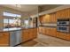 Kitchen with wood cabinets, stainless steel dishwasher and large window with views of the outdoor patio at 15600 E Robin Dr, Fountain Hills, AZ 85268