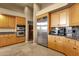 Kitchen with stainless steel appliances, including a double oven and wine refrigerator, and wooden cabinetry at 15600 E Robin Dr, Fountain Hills, AZ 85268