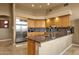Kitchen with stainless steel refrigerator, light wood cabinets, and granite countertops at 15600 E Robin Dr, Fountain Hills, AZ 85268