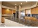 Open kitchen featuring granite counters, wooden cabinets, and modern stainless steel appliances at 15600 E Robin Dr, Fountain Hills, AZ 85268