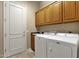 Functional laundry room with ample storage space, cabinets, sink and tile flooring at 15600 E Robin Dr, Fountain Hills, AZ 85268
