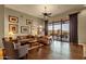 Bright living room with hardwood floors, large windows offering a view, and comfortable leather seating at 15600 E Robin Dr, Fountain Hills, AZ 85268