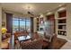 Cozy living room featuring a fireplace, large windows with a scenic view, and comfortable, classic furniture at 15600 E Robin Dr, Fountain Hills, AZ 85268