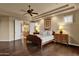 This main bedroom boasts hardwood floors, large windows, a ceiling fan and an ensuite bathroom at 15600 E Robin Dr, Fountain Hills, AZ 85268