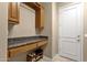 Mud room offers a granite countertop, cabinet storage, and a doorway to the exterior at 15600 E Robin Dr, Fountain Hills, AZ 85268