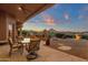 Inviting outdoor patio with a built in oven, dining set, and stunning sunset views at 15600 E Robin Dr, Fountain Hills, AZ 85268
