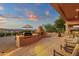 Covered patio showcasing an outdoor kitchen and built-in fireplace at 15600 E Robin Dr, Fountain Hills, AZ 85268