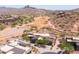 An aerial view of a desert community with a golf course, mountain views, and modern houses at 16134 E Ridgestone Dr, Fountain Hills, AZ 85268