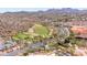 Desert community aerial featuring a winding road, lush greenery, a golf course, and mountain views at 16134 E Ridgestone Dr, Fountain Hills, AZ 85268