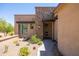 Modern home with desert landscaping and a stone accent wall leading to the front entrance at 16134 E Ridgestone Dr, Fountain Hills, AZ 85268