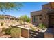 Modern home with desert landscaping, a stone accent wall, and community homes in the background with a blue sky at 16134 E Ridgestone Dr, Fountain Hills, AZ 85268