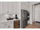 This kitchen is equipped with stainless steel appliances, a wine cooler, and custom white cabinets at 16134 E Ridgestone Dr, Fountain Hills, AZ 85268