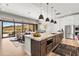 Stunning kitchen with a large island, stainless steel appliances, and an open floor plan leading to a cozy living room at 16134 E Ridgestone Dr, Fountain Hills, AZ 85268