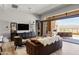 Spacious living room with brown leather sofa and glass doors leading to outdoor patio at 16134 E Ridgestone Dr, Fountain Hills, AZ 85268