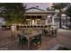 Inviting outdoor patio with comfortable seating, shade structures, and picturesque landscaping at 17625 W Middlebury St, Surprise, AZ 85388