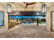 This backyard features a covered patio, outdoor kitchen, and a sparkling pool at 18371 W Roma Ave, Goodyear, AZ 85395