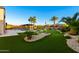Spacious backyard with a pool, pergola, lush landscaping, and putting green, perfect for outdoor living and entertainment at 18371 W Roma Ave, Goodyear, AZ 85395