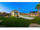 Extensive backyard with a pool, putting green, and well-manicured landscaping, ideal for recreation and outdoor enjoyment at 18371 W Roma Ave, Goodyear, AZ 85395