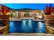 Beautiful backyard pool and outdoor space featuring planters, a fire pit, and comfortable lounge seating at 18371 W Roma Ave, Goodyear, AZ 85395