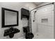 Beautiful bathroom featuring a modern sink, shower with decorative tile, and custom storage at 18371 W Roma Ave, Goodyear, AZ 85395