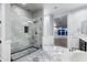 Luxurious bathroom featuring a glass enclosed shower and decorative wall tiles at 18371 W Roma Ave, Goodyear, AZ 85395