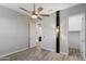 A spacious bedroom features wood-look tile flooring, walk-in closet, and an ensuite bathroom at 18371 W Roma Ave, Goodyear, AZ 85395