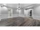 Large bedroom with wood flooring, a modern ceiling fan and outdoor access at 18371 W Roma Ave, Goodyear, AZ 85395
