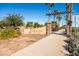 Community entrance with a stone Sedella sign, stone columns and palm trees at 18371 W Roma Ave, Goodyear, AZ 85395
