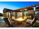 Cozy fire pit area with comfortable lounge chairs in the outdoor living and pool area at 18371 W Roma Ave, Goodyear, AZ 85395