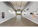 Spacious garage featuring modern lighting, a sleek epoxy floor, and ample room for storage and parking at 18371 W Roma Ave, Goodyear, AZ 85395