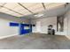 Garage with storage cabinets and epoxy flooring at 18371 W Roma Ave, Goodyear, AZ 85395