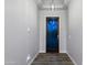 Hallway featuring decorative front door with wood floors, textured walls, and recessed lighting at 18371 W Roma Ave, Goodyear, AZ 85395