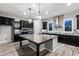Spacious kitchen with granite island, stainless steel appliances, dark cabinets, and stone accents for a modern design at 18371 W Roma Ave, Goodyear, AZ 85395