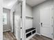 A mud room features a bench, coat hooks, and an exterior door at 18371 W Roma Ave, Goodyear, AZ 85395