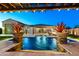 Relaxing pool with water feature and manicured plants, nestled in a backyard retreat, for a peaceful outdoor experience at 18371 W Roma Ave, Goodyear, AZ 85395