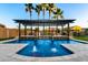 Inviting pool with a pergola and water feature, perfect for relaxation and entertainment in this backyard oasis at 18371 W Roma Ave, Goodyear, AZ 85395