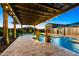 Stunning pool with a pergola, planters, and string lights, creating an inviting atmosphere for outdoor enjoyment at 18371 W Roma Ave, Goodyear, AZ 85395