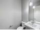 A powder room with a decorative light fixture and pedestal sink at 18371 W Roma Ave, Goodyear, AZ 85395